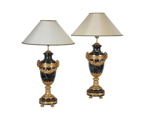 A pair of French green serpentine marble and gilt metal mounted table lamps in Louis XVI style, early 20th century, the fitme