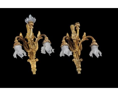 A pair of French gilt brass three light wall brackets in 18th century style, each with frilly glass shades and tied laurel wr