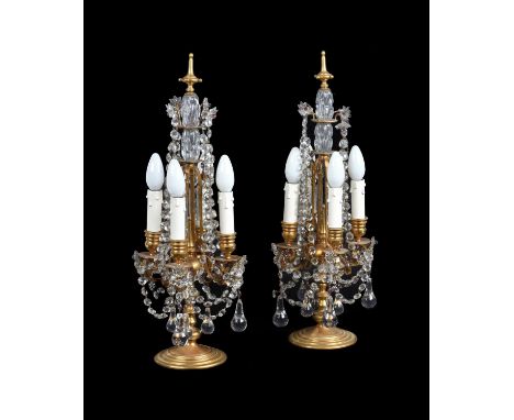 A pair of gilt brass and four light candelabra fitted as table lamps, 20th century, in Louis XV style, the slender frame hung