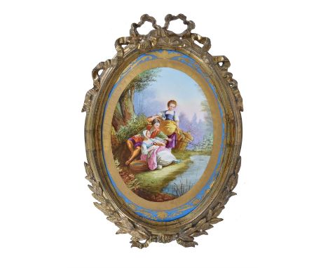 A French porcelain Sevres-style gilt-metal mounted oval wall-plaque, late 19th century, mounted within a gilt-metal frame, 55