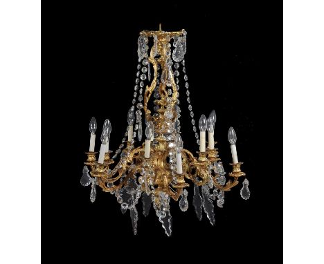 A French gilt metal and cut glass twelve light chandelier in Louis XVI style, late 19th/early 20th century, the foliate cast 