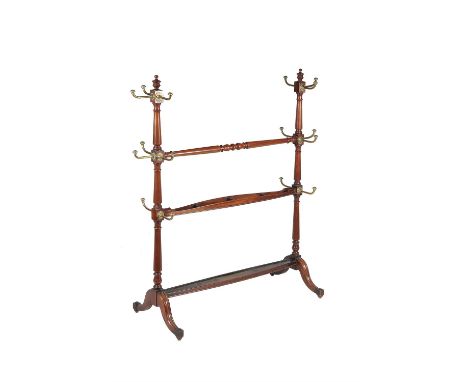 A late Victorian mahogany and brass hall stand, circa 1880, in the manner of Jas. Shoolbred, with two uprights, each with bra