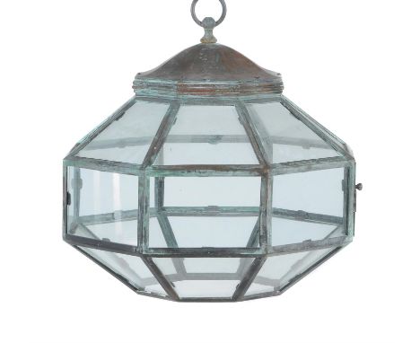 A glazed copper hanging light of octagonal section, late 19th century, with a series of glazed panels within a lattice frame,