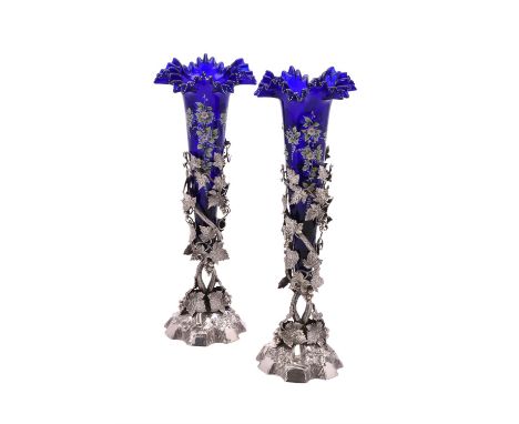 A pair of Victorian silver trumpet vases by Alexander Macrae, London 1865, openwork fruiting vine on rocky domed bases, 34cm 