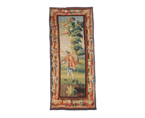 A French pastoral tapestry fragment, mid-18th century, loosely in the style of Oudry, depicting a flamboyant male figure in a