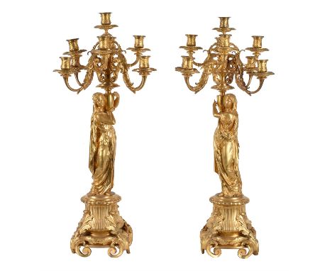 A pair of Napoleon III ormolu nine light figural candelabra, mid-19th century, each with a central raised sconce above tiers 