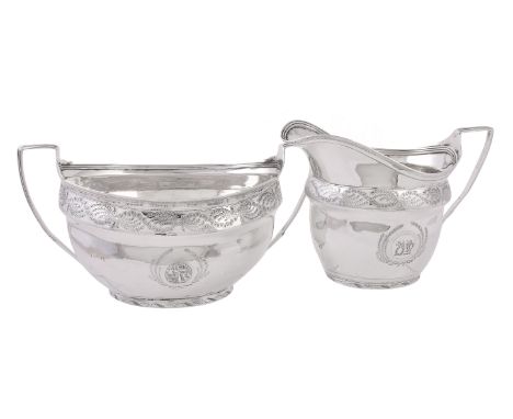 A George III silver oval sugar basin and cream jug, maker's marks worn (A..?), London 1804, with threaded rims and handles, e