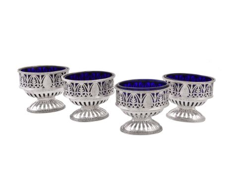 A set of four George IIII silver oval pedestal salt cellars by Robert Hennell I, London 1775, with beaded rims, pierced with 
