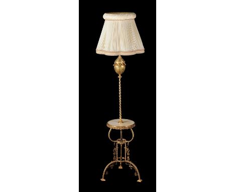 A French gilt metal standard lamp, late 19th century and later adapted, formerly an oil lamp, the urn reservoir above a spira