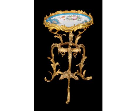 A French assembled porcelain and gilt-metal tripod occasional table in the rococo manner, late 19th century, the top inset wi