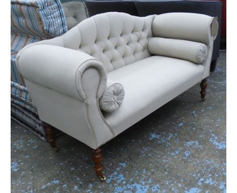 SOFA, two seater button back in neutral fabric on turned castor supports, 141cm L. 