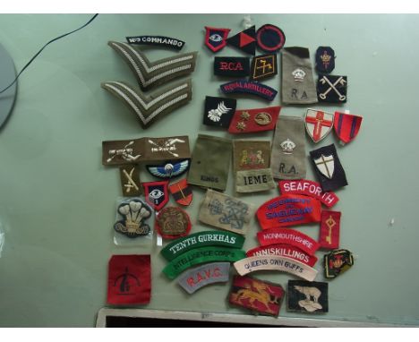 Seventeen British Divisional cloth patches, twelve shoulder titles and fourteen assorted insignia from the Halifax Army Museu
