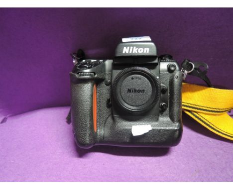 A Nikon SLR F5 body with guide and instruction manual