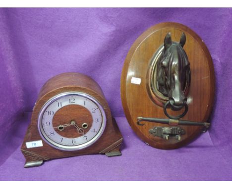 A vintage metal pressed horse head on plaque and mantle clock