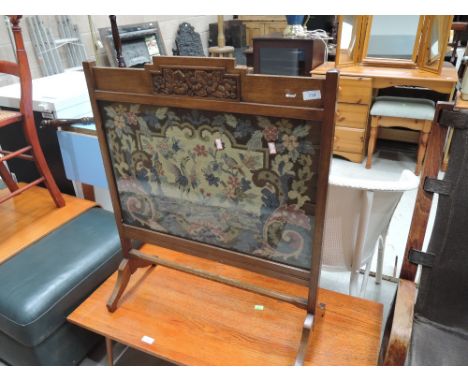 An oak framed fire screen with tapestry centre