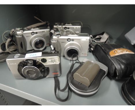 Four Canon cameras. A Sureshot 105 zoom, three Powershot G3, camera bag etc
