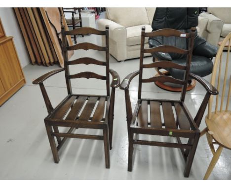 Two modern dark stained Ercol carver chairs