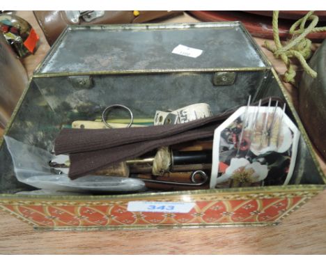 A selection of vintage sewing and leather working tools