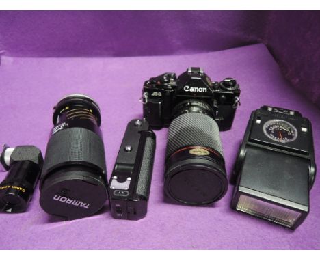 A Canon A1 35mm camera with Tokina 35-200mm zoom lens, Power winder, Tamron 80-210mm lens, instruction booklet and original b