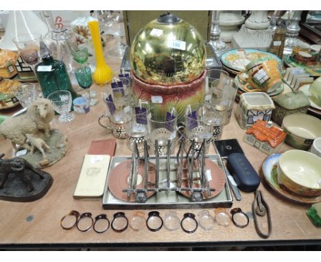 A selection of vintage decorations including art deco design toast rack and large bauble