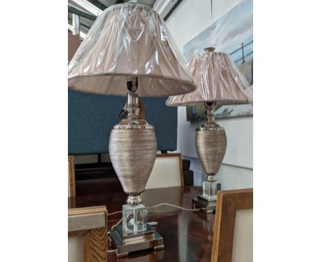 GENESIS UTTERMOST LIGHTING TABLE LAMPS, a pair,   beige shades, rusticated barrel form columns, lucite and chrome bases, cont