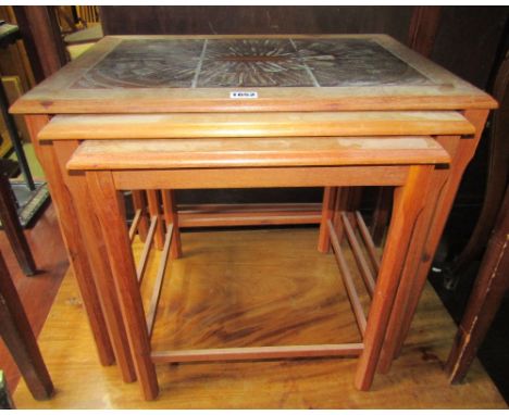 A nest of three 1970s teakwood occasional tables of graduated form with ceramic tile tops of Danish design and construction