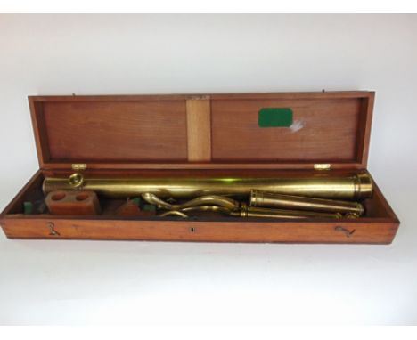 A 19th century mahogany cased brass telescope with folding tripod stand and lenses, the case 84cm long