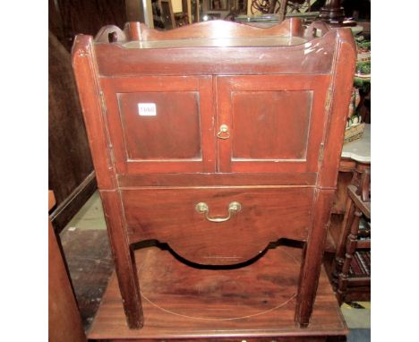 A Georgian mahogany tray top commode, the front elevation enclosed by a  pair of panelled doors raised on moulded supports