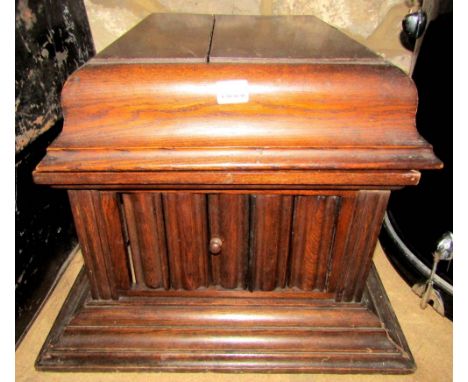 A vintage oak table top and portable wind up gramophone with shaped and moulded hinged lid bearing a transfer printed label t
