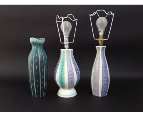 Two Poole pottery lamp bases with stylised striped and circle decoration in tones of green, mauve and grey, one with impresse