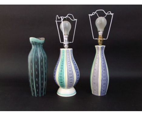 Two Poole pottery lamp bases with stylised striped and circle decoration in tones of green, mauve and grey, one with impresse