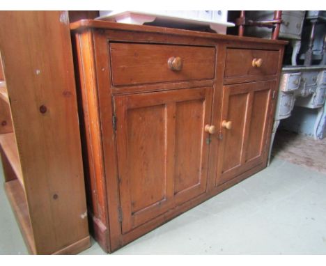 A vintage stained pine kitchen dresser, the base enclosed by a pair of twin rectangular moulded doors with two frieze drawers