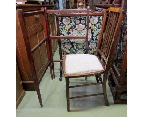 An Edwardian mahogany firescreen with drawn threadwork panel on a floral theme in an Art Nouveau manner, shaped frame with cl