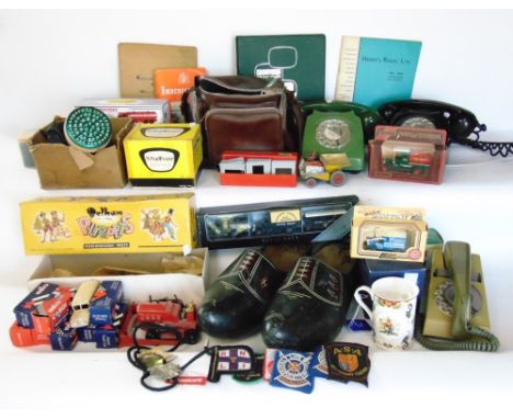 Two boxes of various miscellaneous items to include vintage telephones, Pelham Puppet, vintage die cast toys, gas mask, vinta