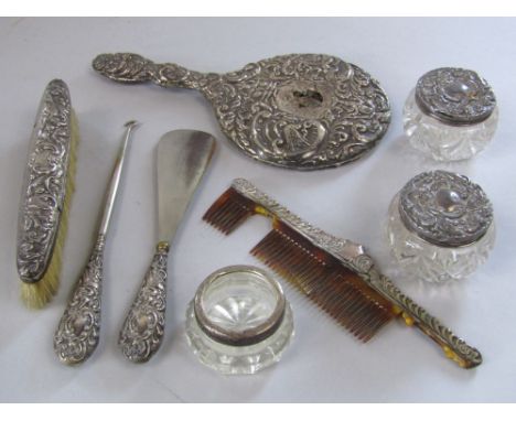 A collection of dressing set items comprising a mirror, a brush, a comb, shoe horn and lace hook and three lidded jars