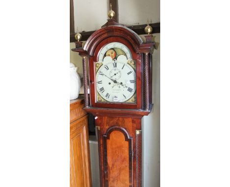 A Regency mahogany longcase clock, the full length door cross banded in rosewood, the hood with spiral column supports enclos