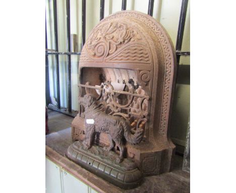 A small vintage cast iron Riplingales stove of arched form with decorative foliate and further detail together with a cast ir