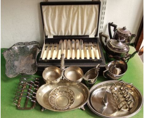 A mixed collection of silver plate to include four piece tea service, cased canteens of cutlery, baskets, etc