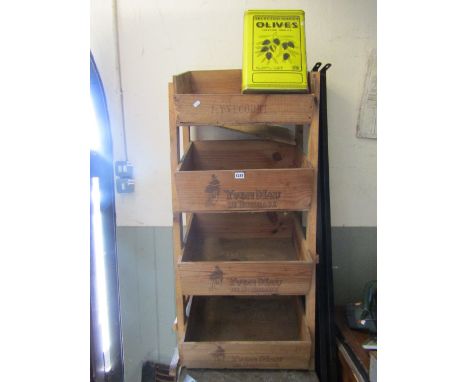 A rustic pine framed wine bottle rack/stand with four integral sloping boxes together with a vintage selected Greek printed o