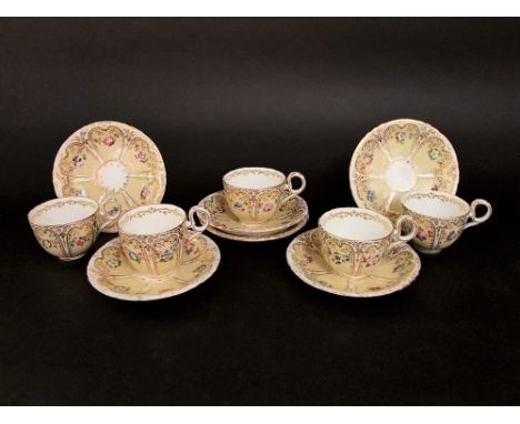 Victorian porcelain part tea service comprising five cups and six saucers, decorated with floral sprays within gilt arches up