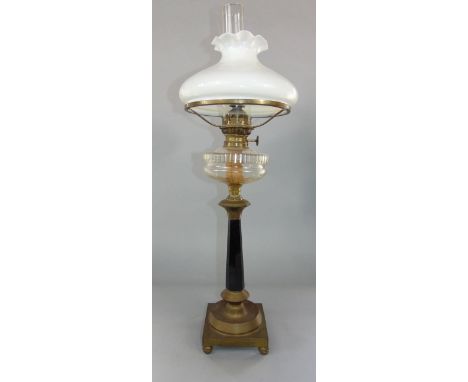 A good quality 19th century oil lamp with clear cut glass reservoir and faceted black column upon a stepped circular plateau 