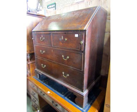 A Georgian oak bureau, the fall flap enclosing a fitted interior of small drawers and pigeon holes over with two long and two