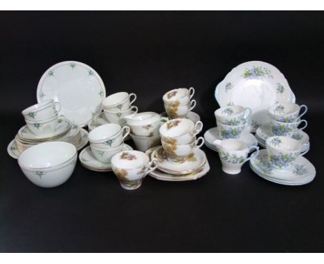 A collection of Shelley tea wares in three different patterns including examples with bridge and river landscape detail, comp