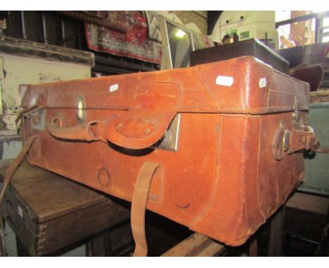 A vintage stitched tan leather suitcase with twin lock and reinforced corners