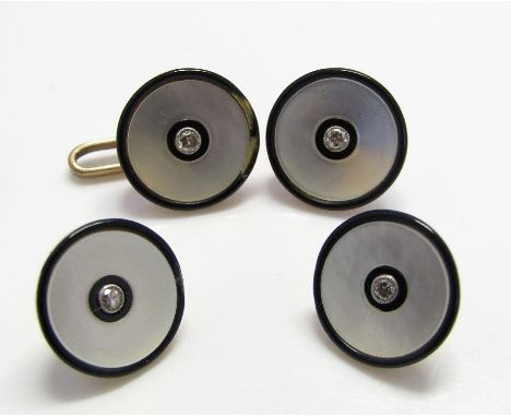 Four 18ct art deco mother of pearl buttons, each set with a diamond and with black enamel border, 5g total (one border af)