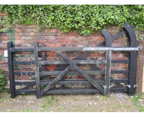 A five bar wooden entrance or field gate, chamfered frame and ebonised finish, together with a matching smaller example, the 