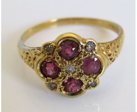 An 18ct pink ruby and diamond ring of quatrefoil form with ornately engraved decoration to shank, size R/S, 4g