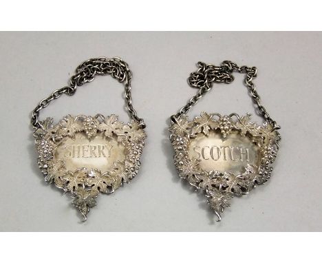 Two late 20th century silver decanter labels for scotch and sherry, each cast with grapevine