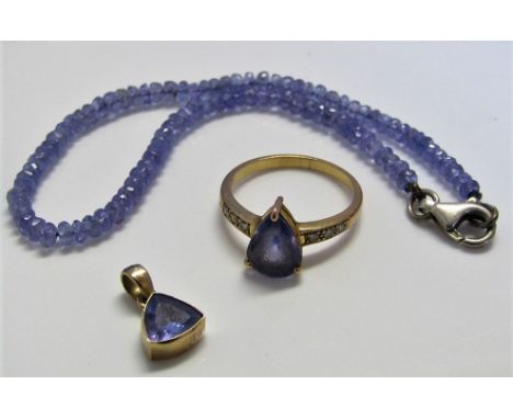 Three tanzanite items comprising 14ct ring with pear cut tanzanite and diamond set shoulders, size M, 9ct pendant and a tanza