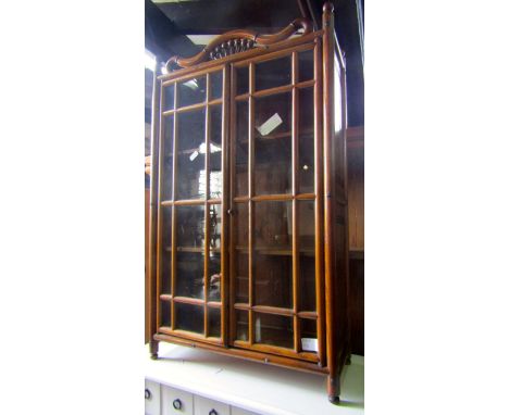 A small continental oak framed table or wall hanging cabinet enclosed by a pair of full length glazed and moulded segmented p